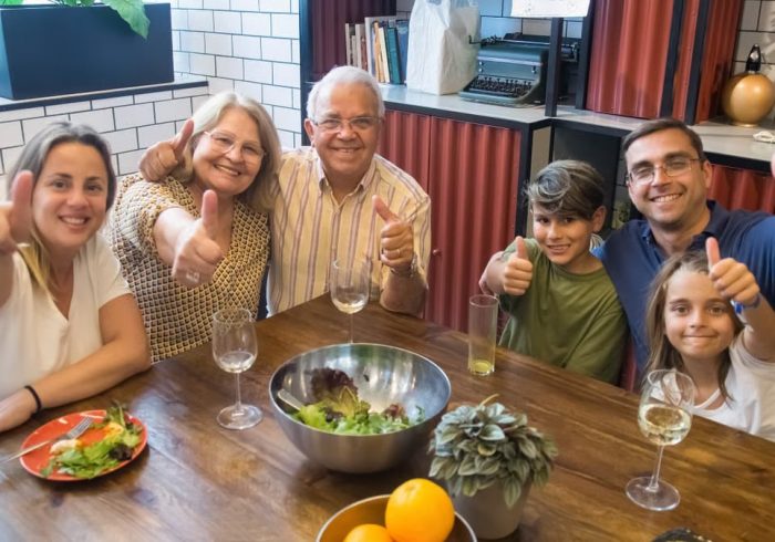 A happy family enjoying a meal together, showcasing togetherness and joy at a dining table.