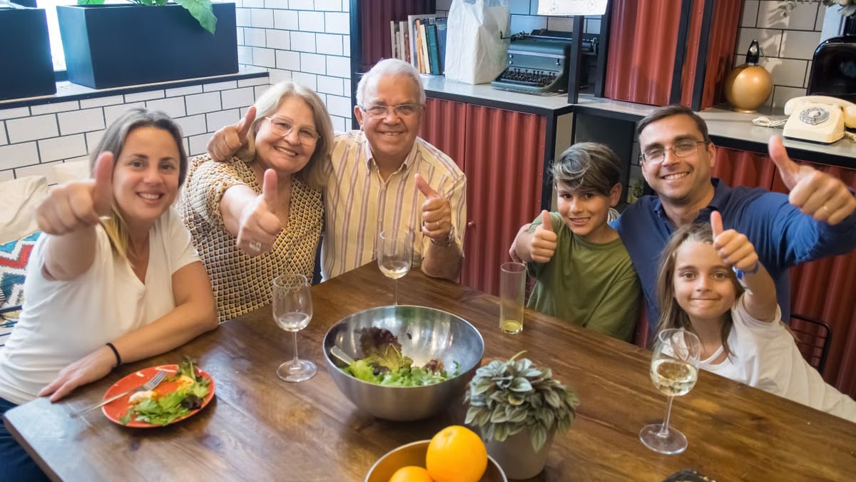 A happy family enjoying a meal together, showcasing togetherness and joy at a dining table.